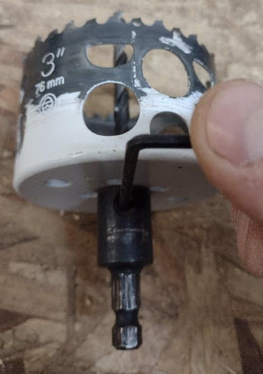 Pilot bit being removed from the hole saw.
